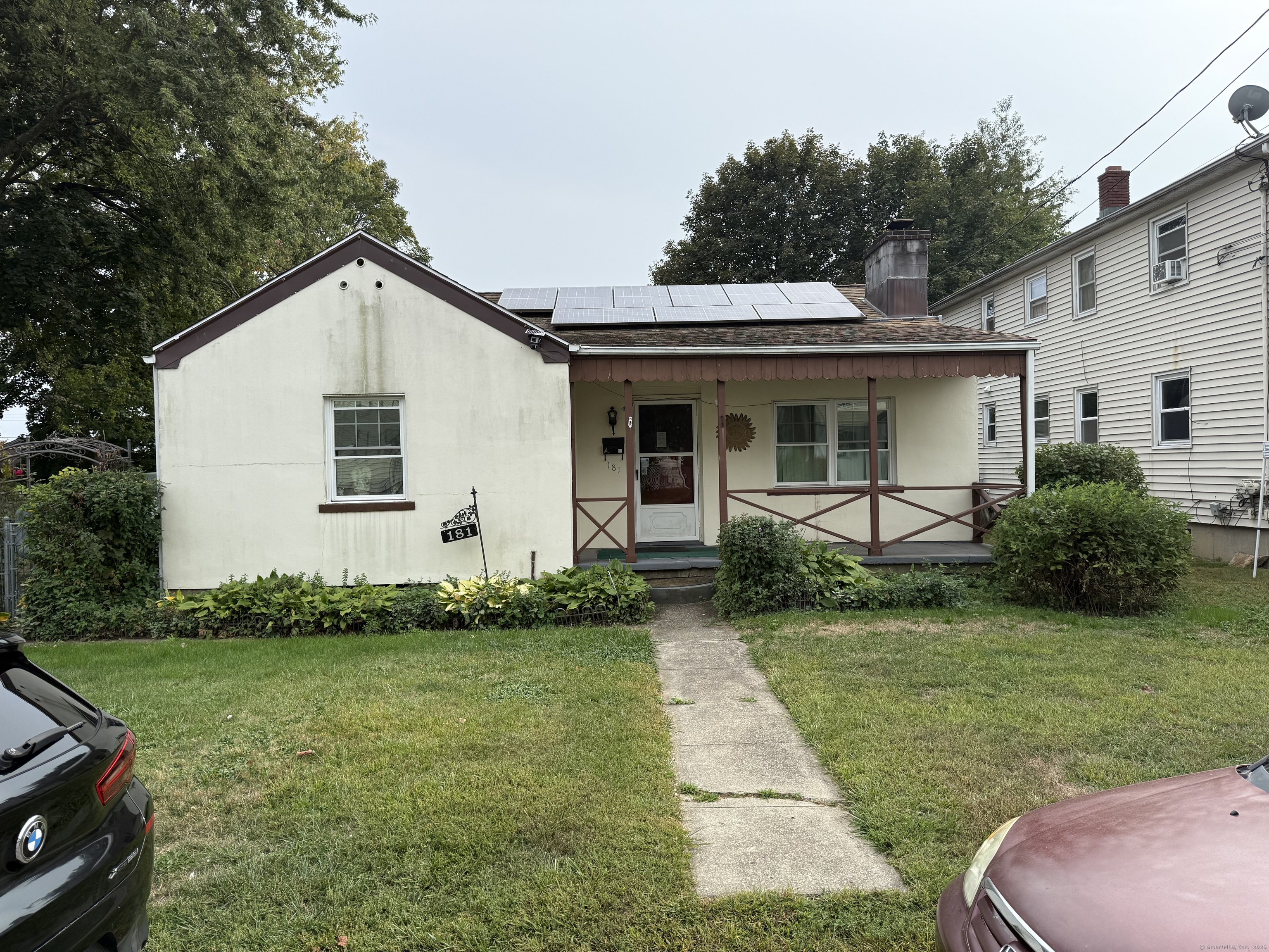 a front view of a house with a garden