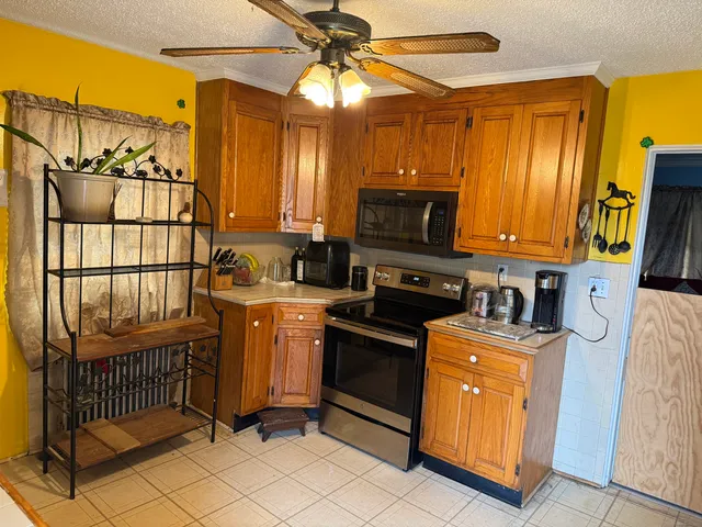 a kitchen that has a sink and a stove top oven