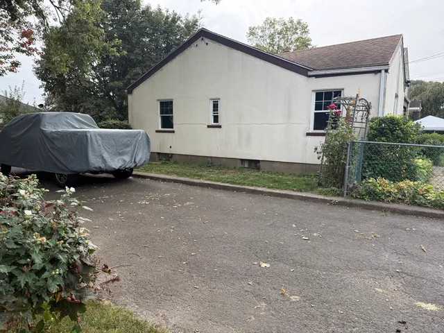 a view of a house with a yard and a garage