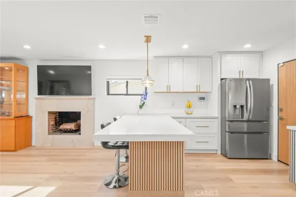 a kitchen with refrigerator cabinets and wooden floor