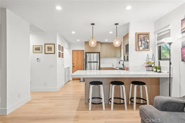 a living room with furniture and a kitchen view