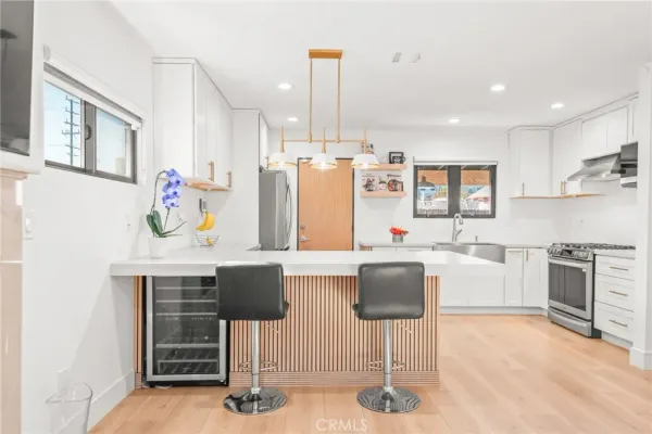 a kitchen with cabinets and chairs