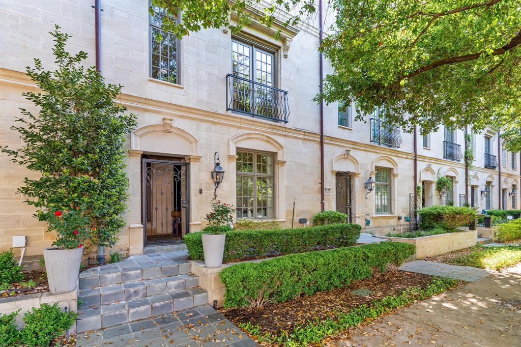 a front view of a house with garden and trees