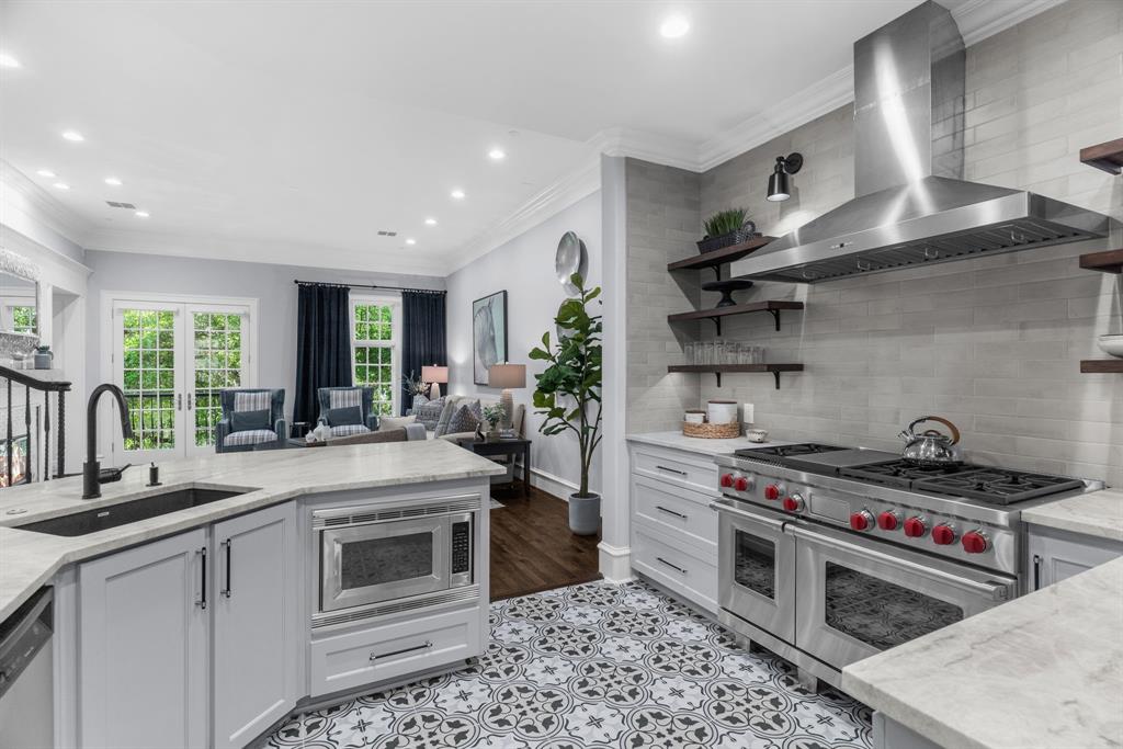 2222 Worthington Street Dallas, TX 75204 - Photo 13 of 39 a kitchen with stainless steel appliances granite countertop a stove and a sink