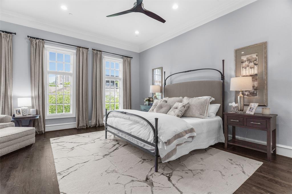 2222 Worthington Street Dallas, TX 75204 - Photo 22 of 39 a spacious bedroom with a bed a couch and large window