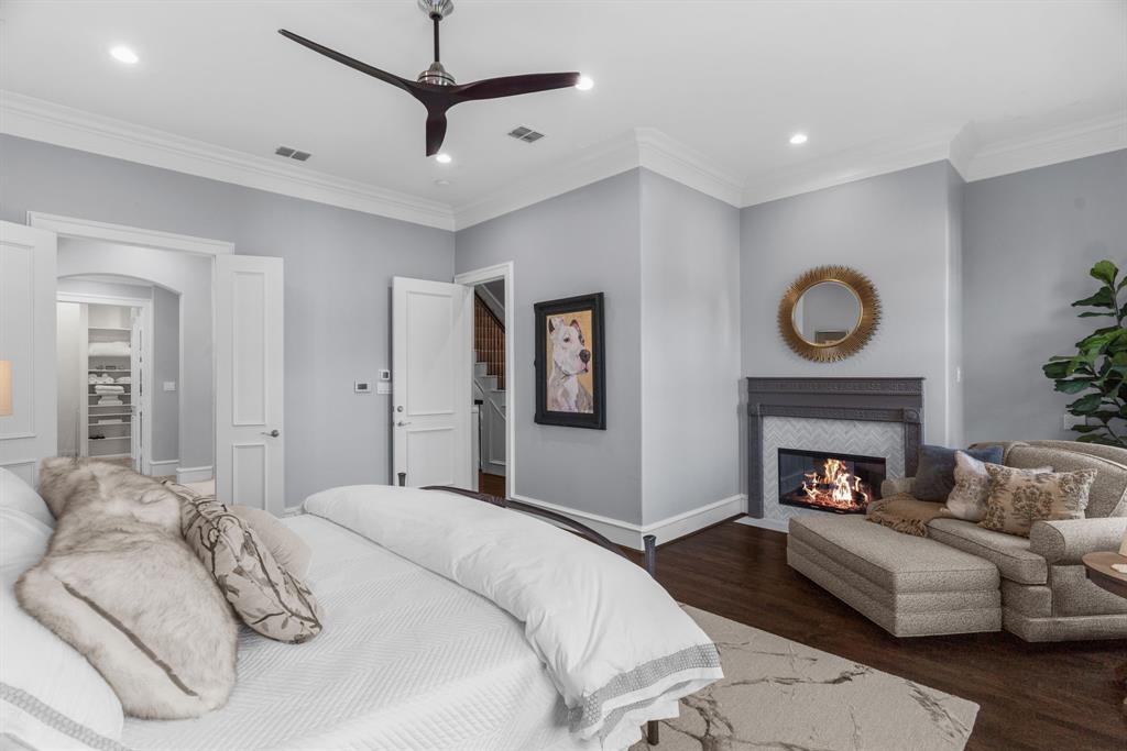 2222 Worthington Street Dallas, TX 75204 - Photo 24 of 39 a bedroom with a bed and a fireplace