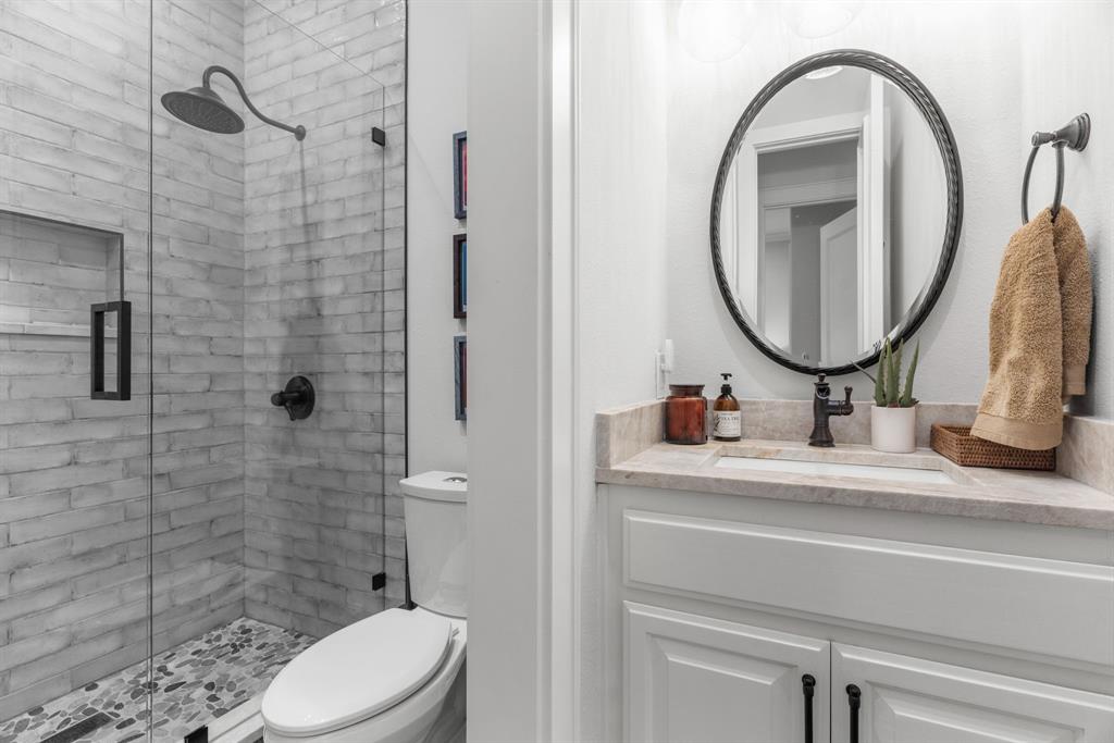 2222 Worthington Street Dallas, TX 75204 - Photo 32 of 39 a bathroom with a sink a toilet and a mirror