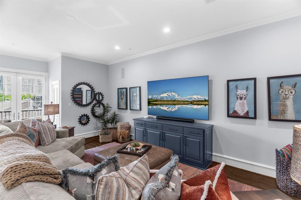 2222 Worthington Street Dallas, TX 75204 - Photo 34 of 39 a living room with furniture and a flat screen tv