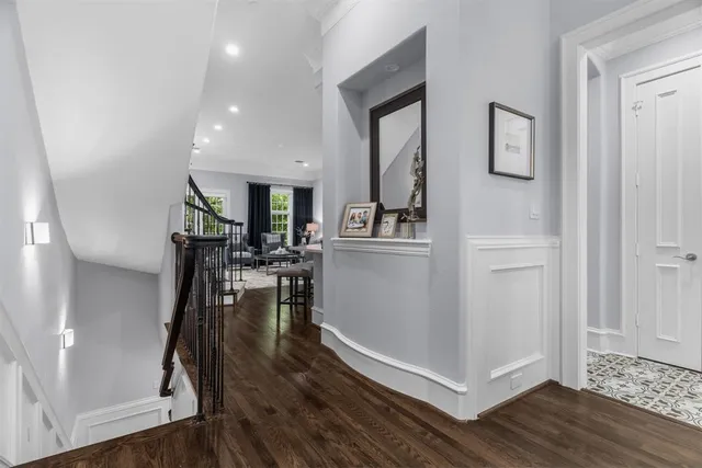 a view of a living room with wooden floor and a kitchen