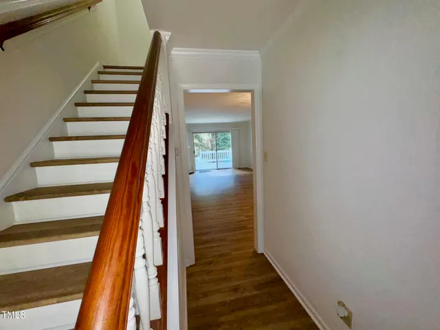 a view of entryway and hall with wooden floor