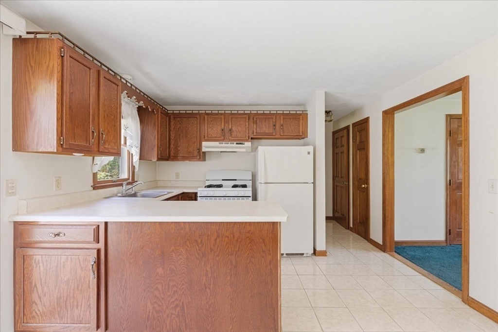46 Willow Ridge Drive, Unit 46 Bridgewater, MA 02324 - Photo 12 of 40 a kitchen with stainless steel appliances a refrigerator and a stove top oven