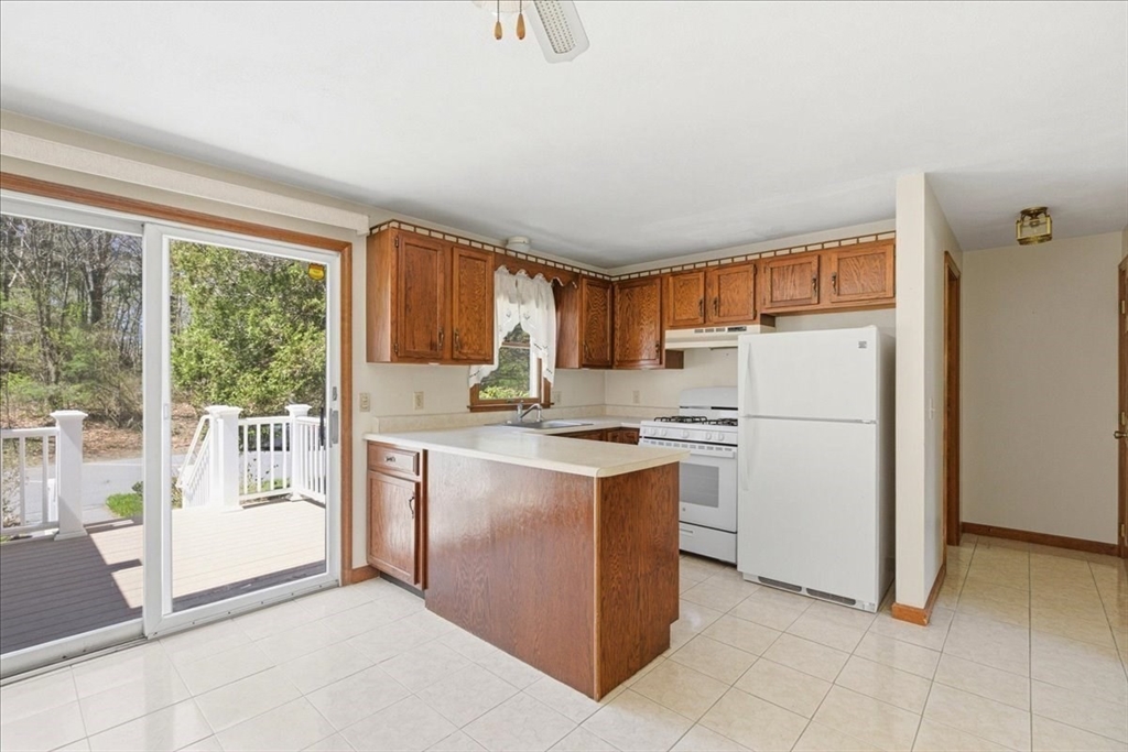 46 Willow Ridge Drive, Unit 46 Bridgewater, MA 02324 - Photo 13 of 40 a kitchen with white cabinets and white appliances