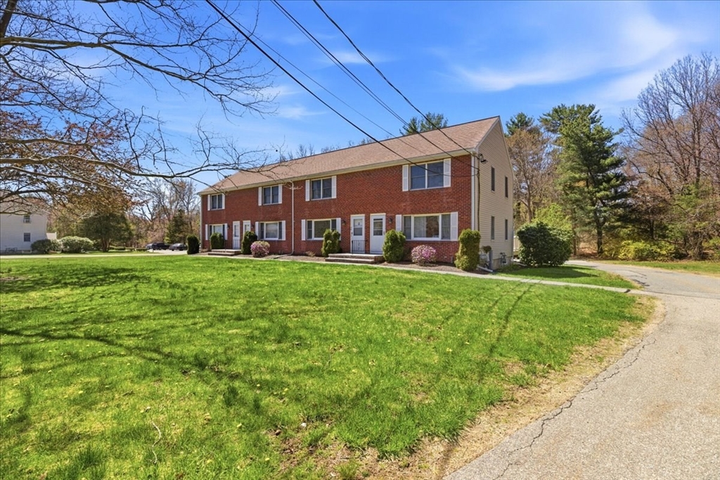 46 Willow Ridge Drive, Unit 46 Bridgewater, MA 02324 - Photo 2 of 40 front view of a building with a yard