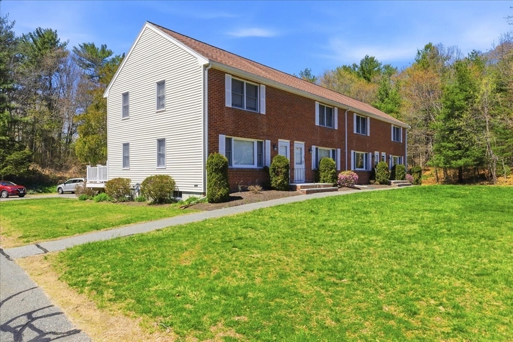 46 Willow Ridge Drive, Unit 46 Bridgewater, MA 02324 - Photo 3 of 40 a front view of a house with a yard and trees