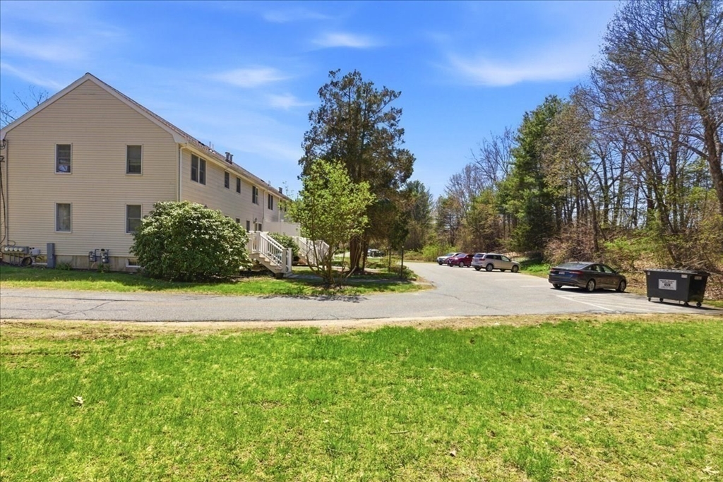 46 Willow Ridge Drive, Unit 46 Bridgewater, MA 02324 - Photo 40 of 40 a view of a white house with a yard and potted plants