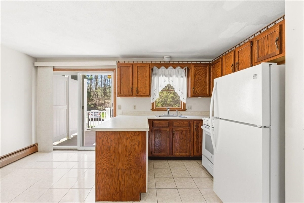 46 Willow Ridge Drive, Unit 46 Bridgewater, MA 02324 - Photo 10 of 40 a kitchen with stainless steel appliances a refrigerator and a stove