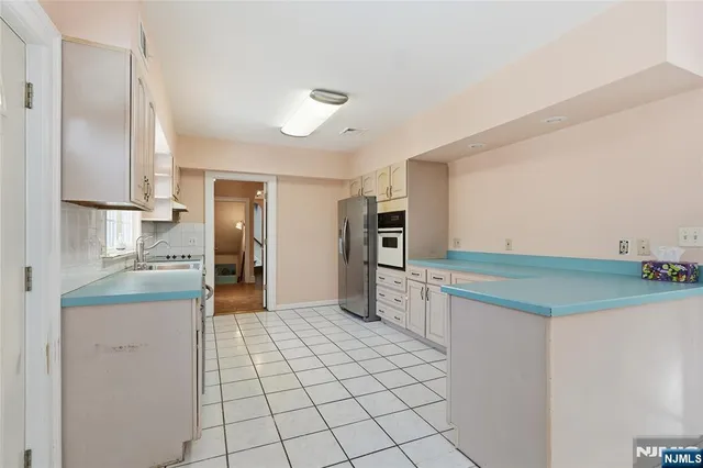 a kitchen with stainless steel appliances a refrigerator and a sink