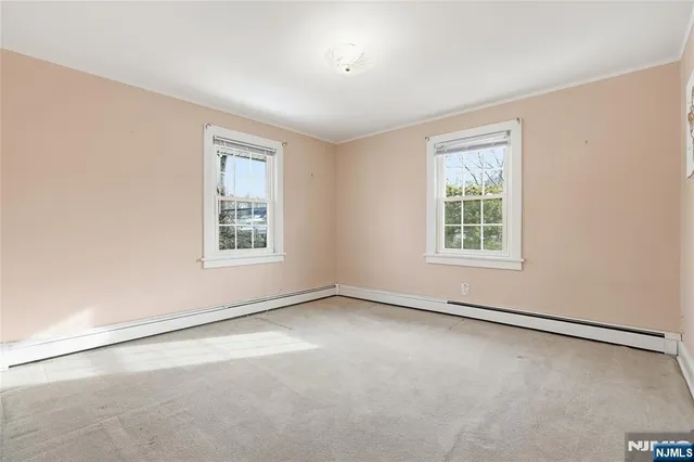 a bathroom with a double vanity sink toilet mirror and shower