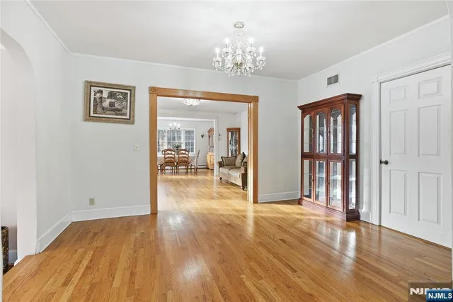 a view of a livingroom with wooden floor and furniture