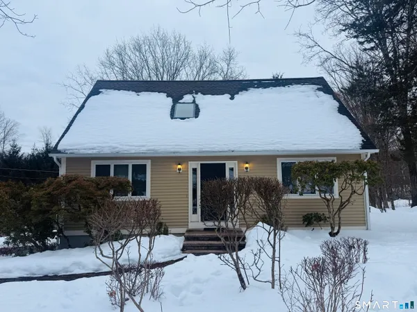 a front view of house with yard and seating space