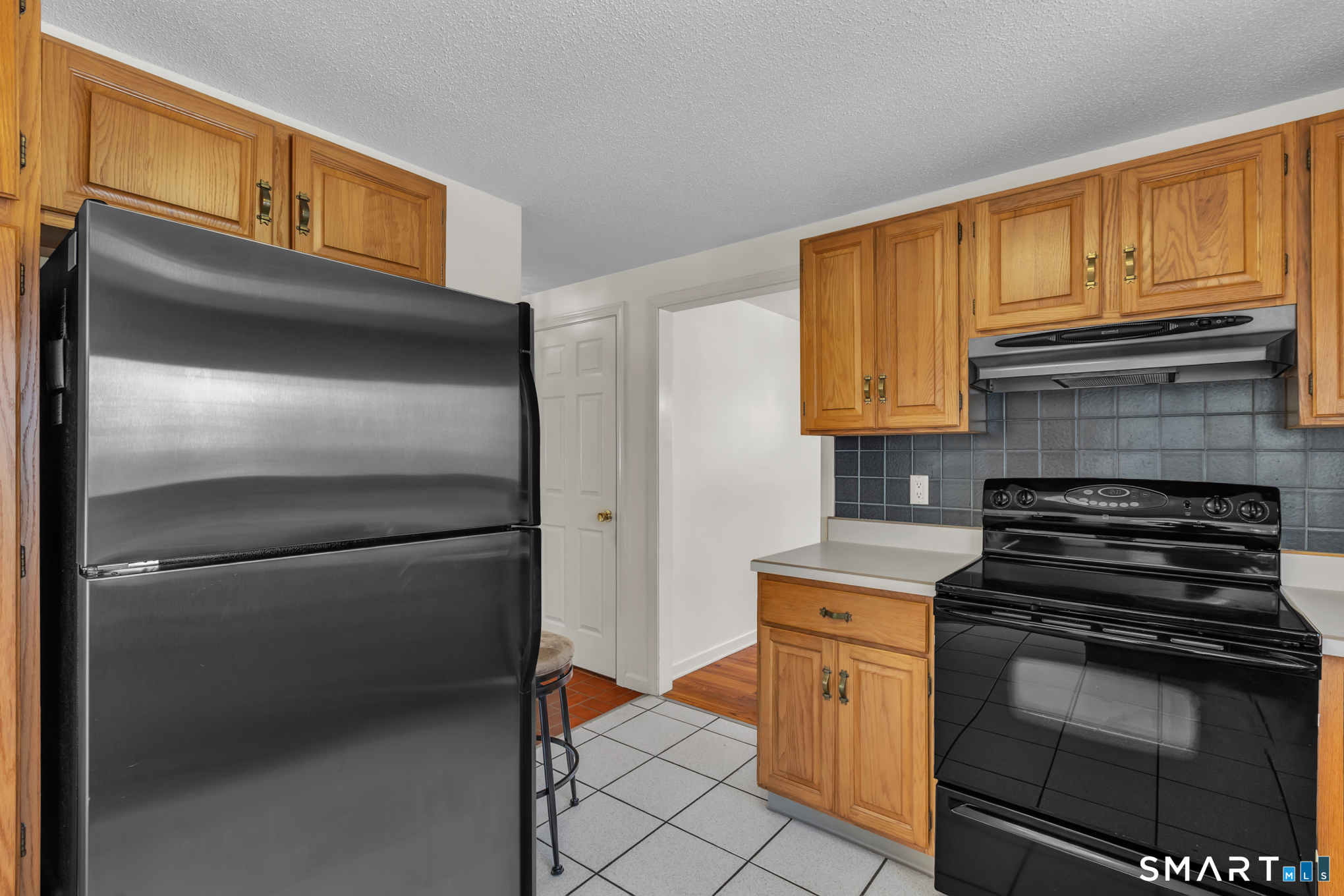 550 High Street Coventry, CT 06238 - Photo 13 of 35 a kitchen with appliances cabinets and a counter top space