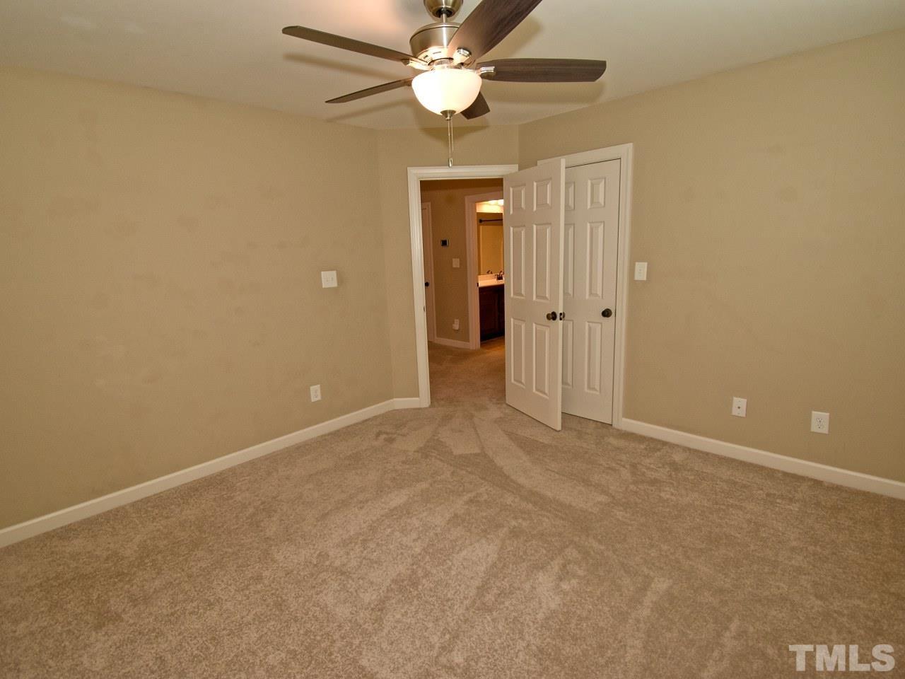64 Hackney Trail Clayton, NC 27527 - Photo 22 of 30 an empty room with closet and a ceiling fan