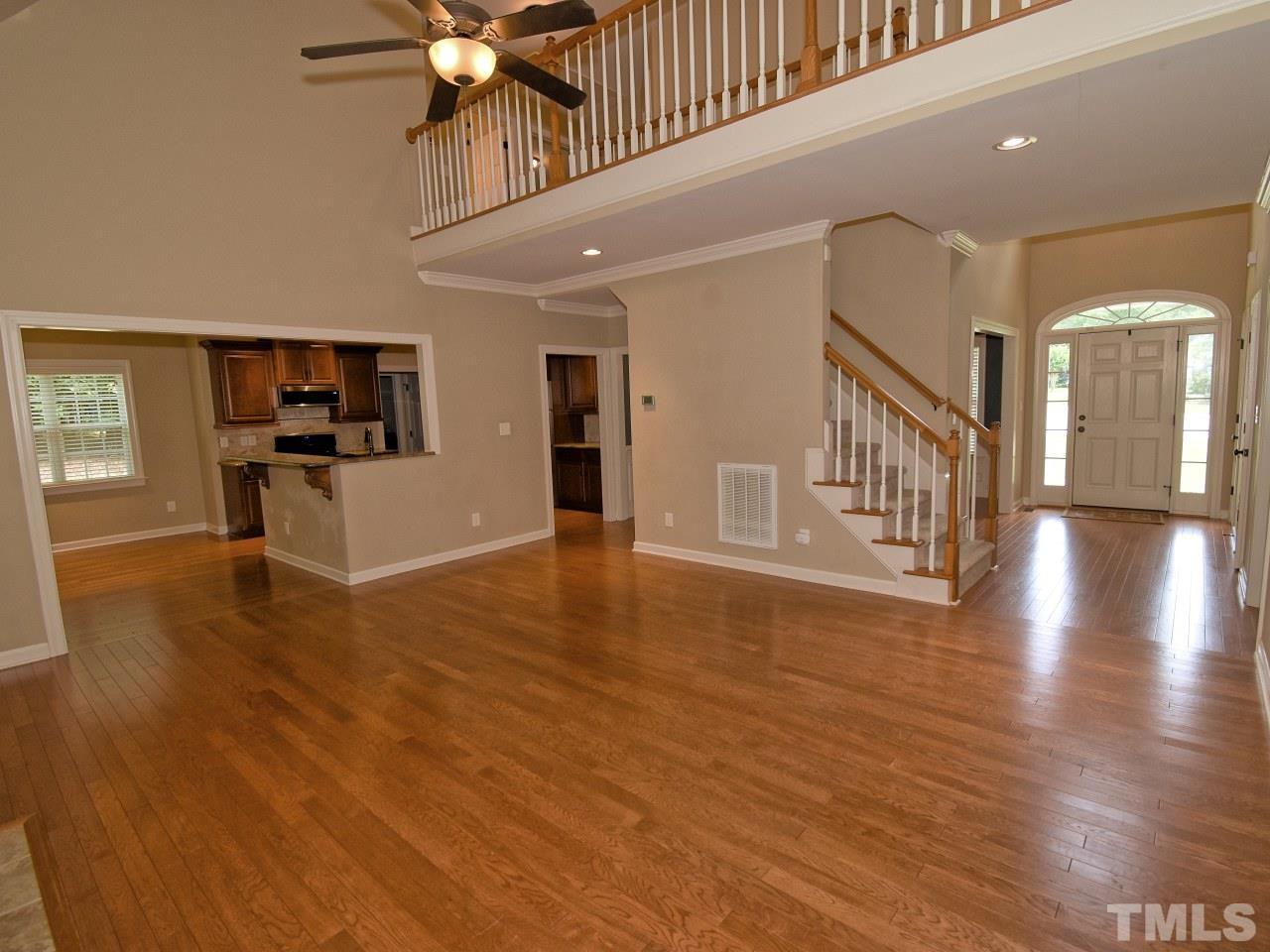 64 Hackney Trail Clayton, NC 27527 - Photo 9 of 30 a view of an empty room with window and wooden floor