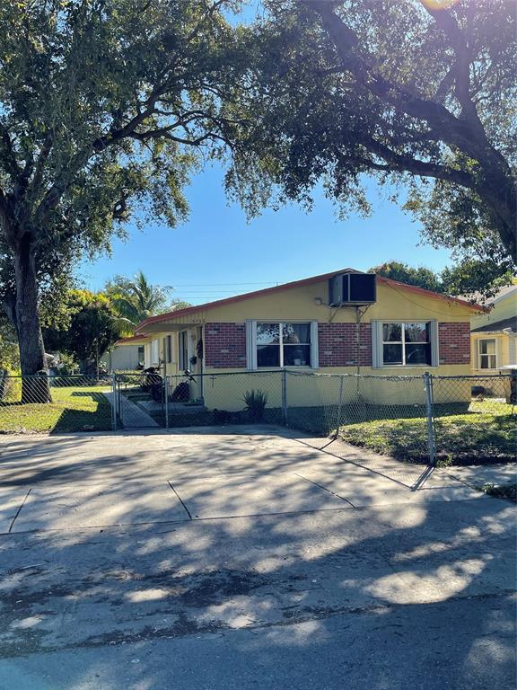5738 Lincoln Street, Unit B Hollywood, FL 33021 - Photo 2 of 25 a view of a yard in front of a house