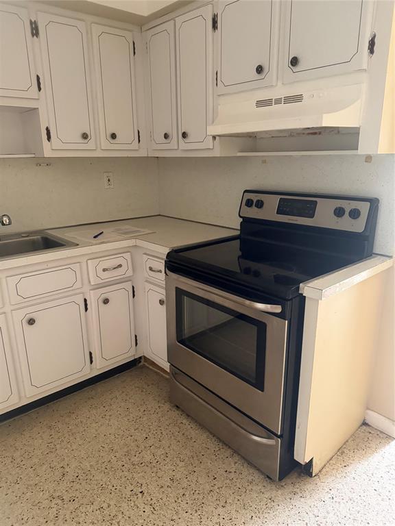 5738 Lincoln Street, Unit B Hollywood, FL 33021 - Photo 21 of 25 a kitchen with white cabinets and a stove
