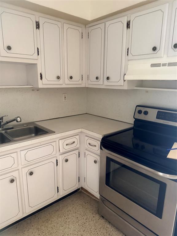5738 Lincoln Street, Unit B Hollywood, FL 33021 - Photo 22 of 25 a kitchen with white cabinets and white appliances