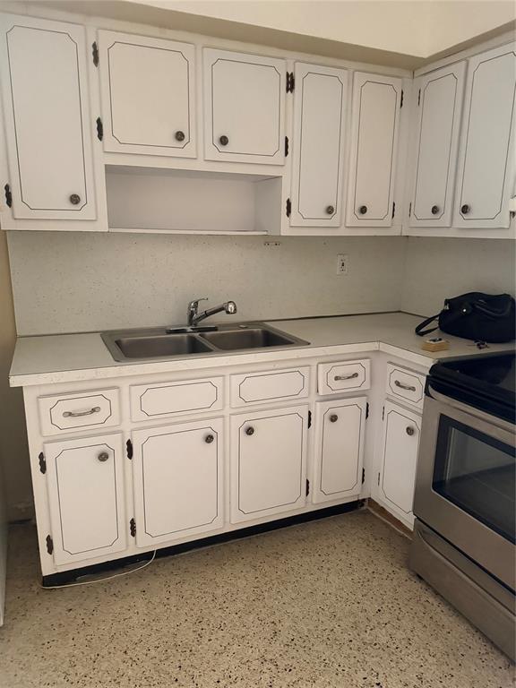 5738 Lincoln Street, Unit B Hollywood, FL 33021 - Photo 23 of 25 a kitchen with white cabinets and white appliances