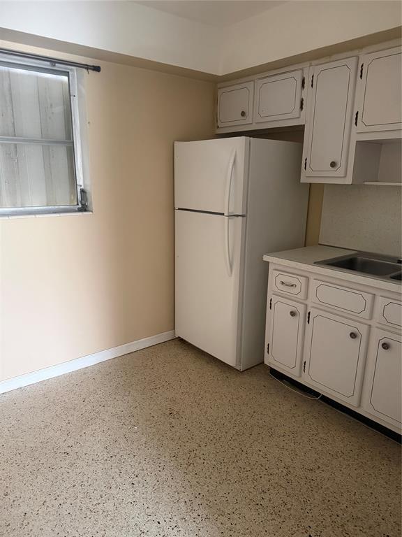 5738 Lincoln Street, Unit B Hollywood, FL 33021 - Photo 24 of 25 a view of a kitchen with cabinets