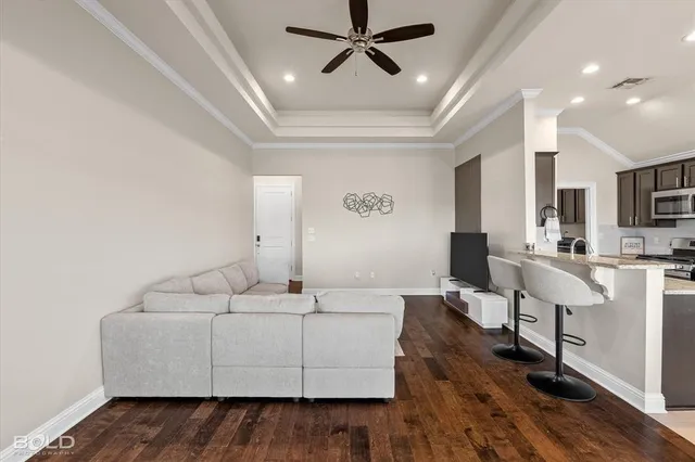 a living room with furniture and a wooden floor