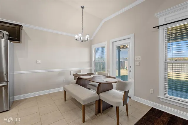 a view of a dining room with furniture and window