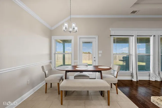 a view of a dining room with furniture wooden floor and chandelier