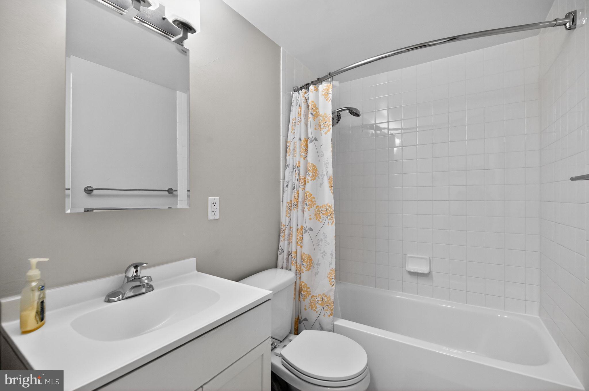 1101 3rd Street Southwest, Unit 111 Washington, DC 20024 - Photo 18 of 40 a bathroom with a sink mirror toilet and bathtub
