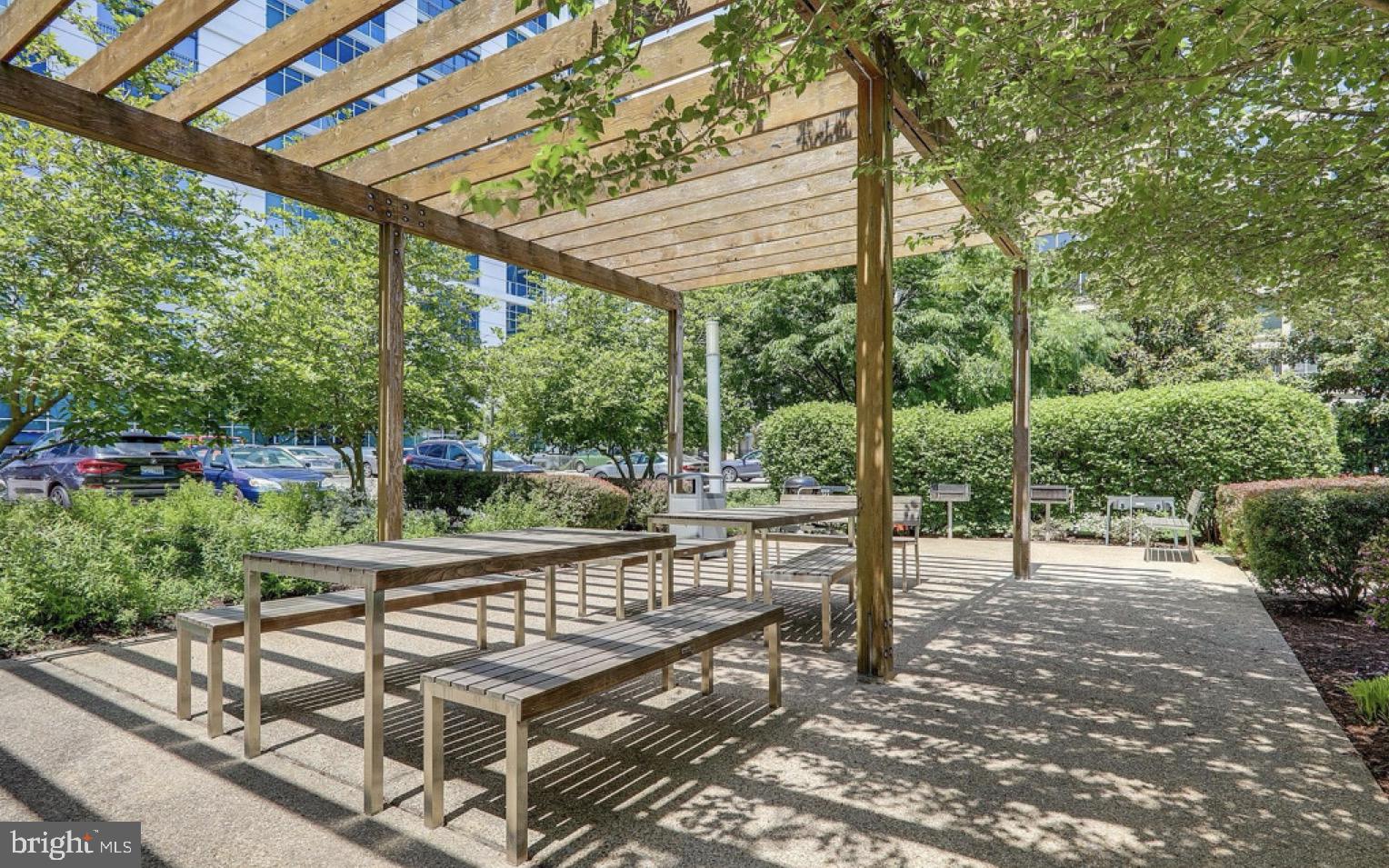 1101 3rd Street Southwest, Unit 111 Washington, DC 20024 - Photo 27 of 40 a view of a patio with a table chairs and a backyard