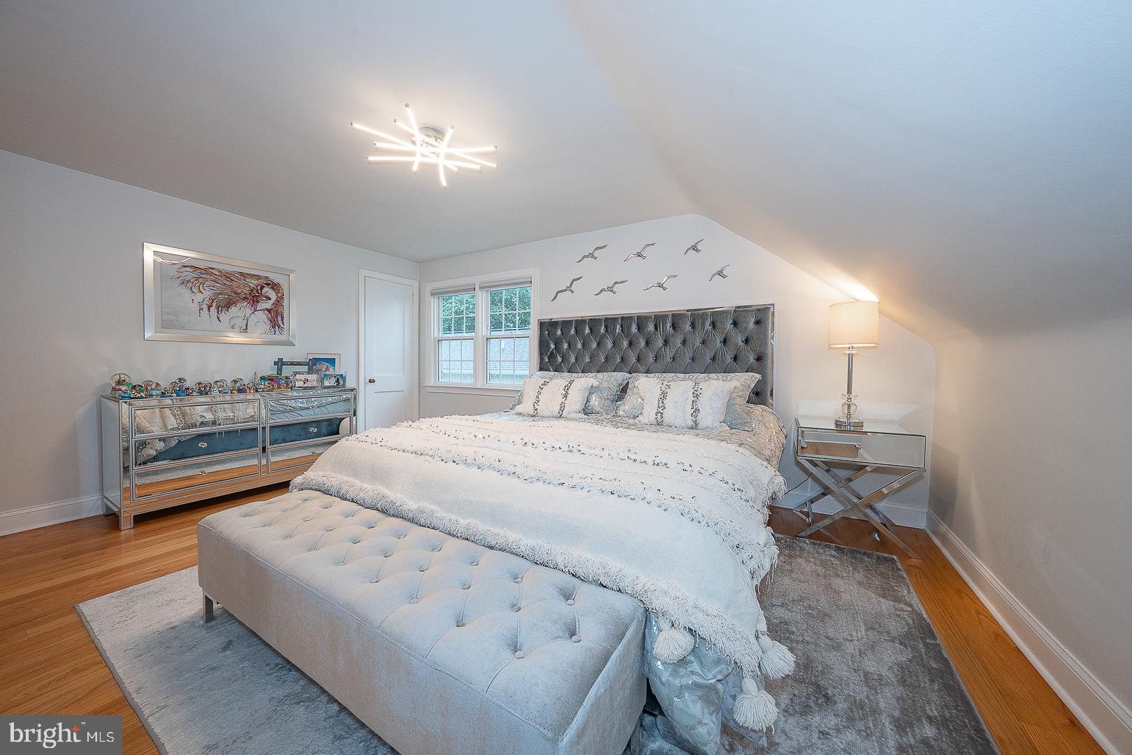 220 Dorset Road Devon, PA 19333 - Photo 21 of 32 a bedroom with a bed and a chandelier