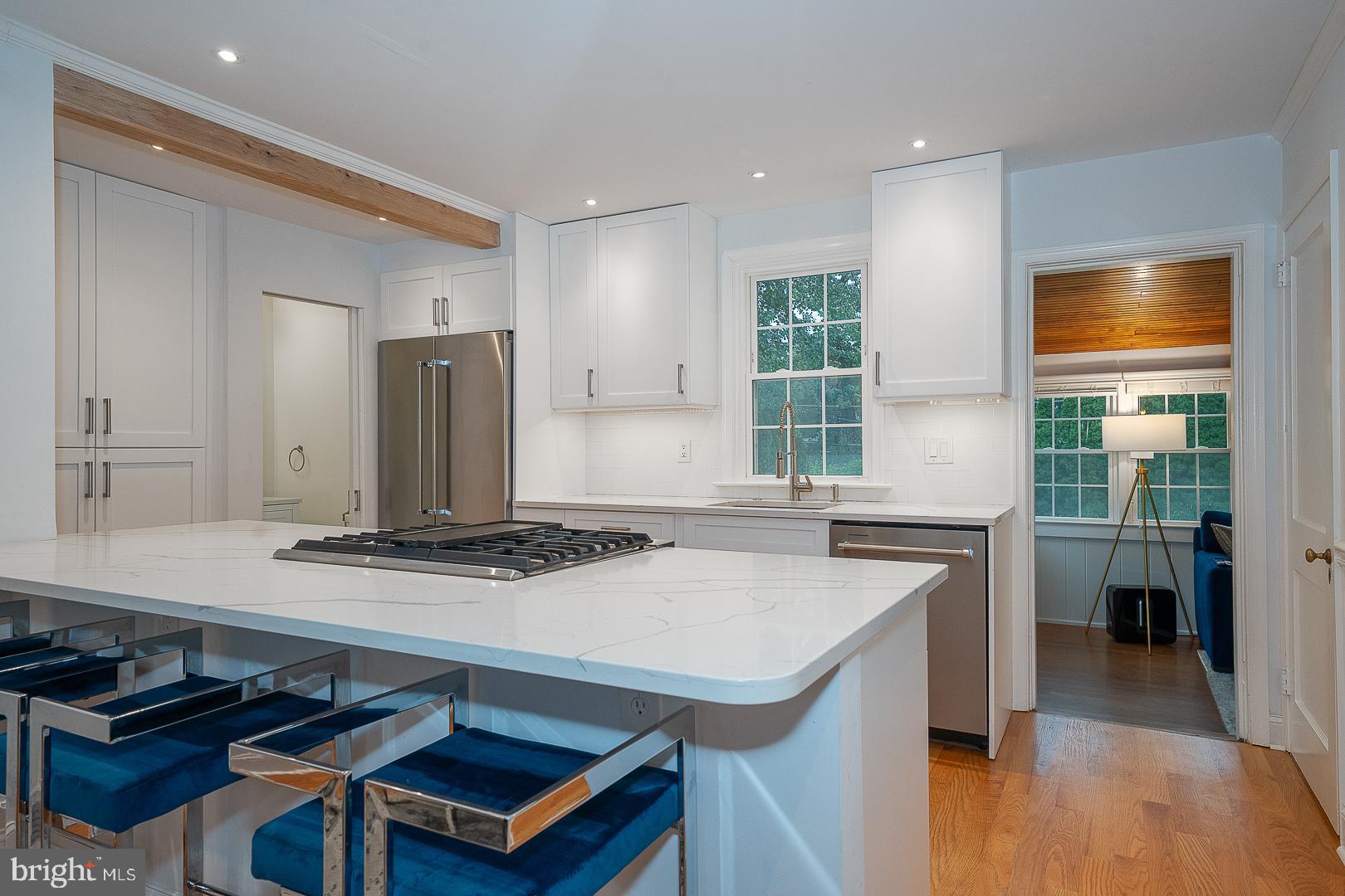220 Dorset Road Devon, PA 19333 - Photo 9 of 32 a kitchen with stainless steel appliances granite countertop a stove a refrigerator and a dining table
