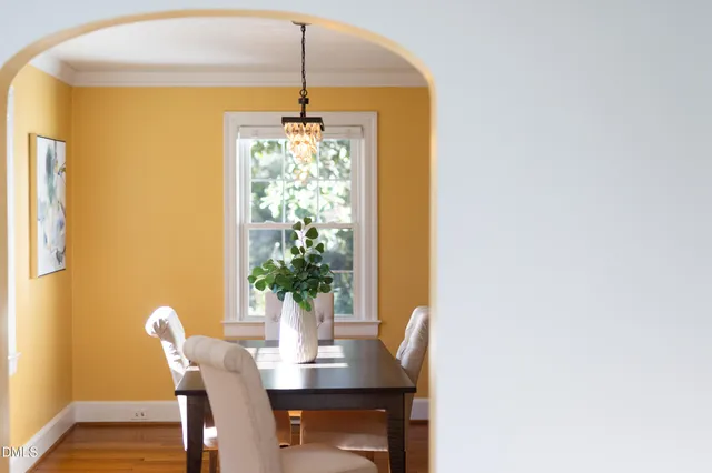 a dining room with furniture and wooden floor