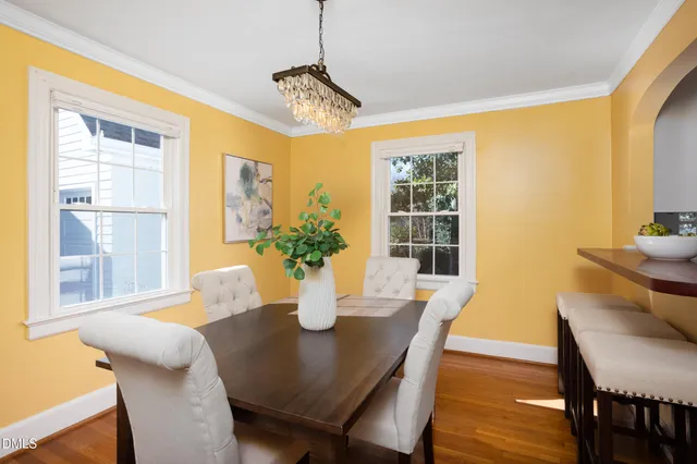 a view of a dining room with furniture and chandelier