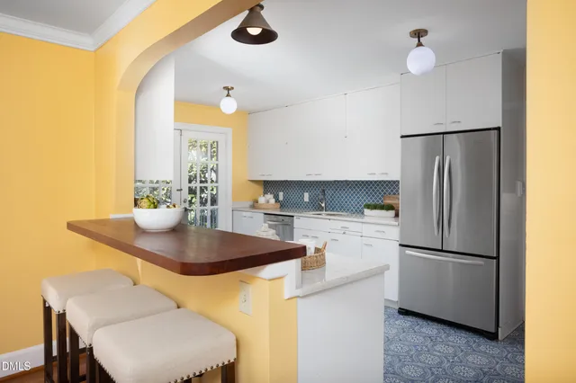 a view of cabinets a sink and a stove