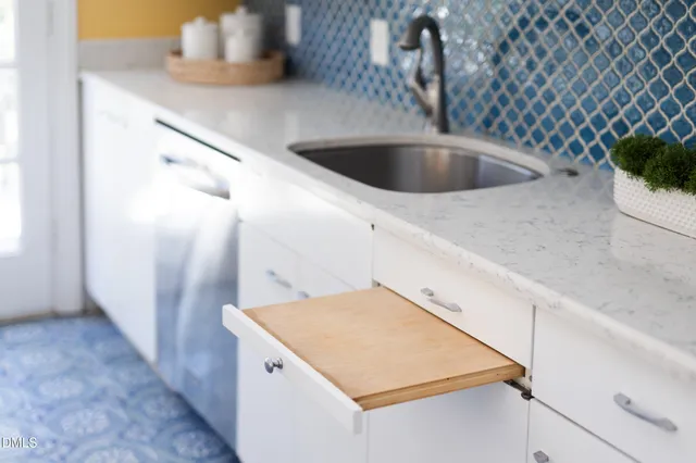 a kitchen with refrigerator and cabinets