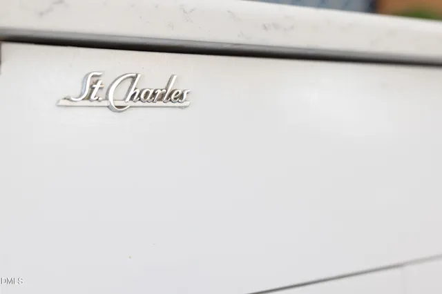 a large white kitchen with a sink a stove and cabinets