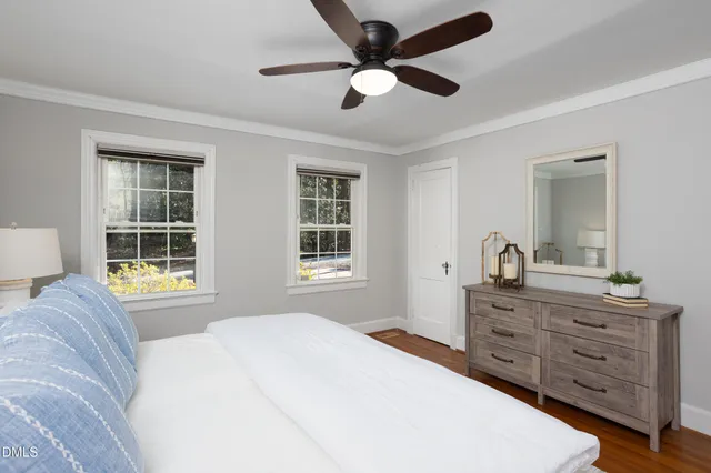 front view of a house with a yard and potted plants