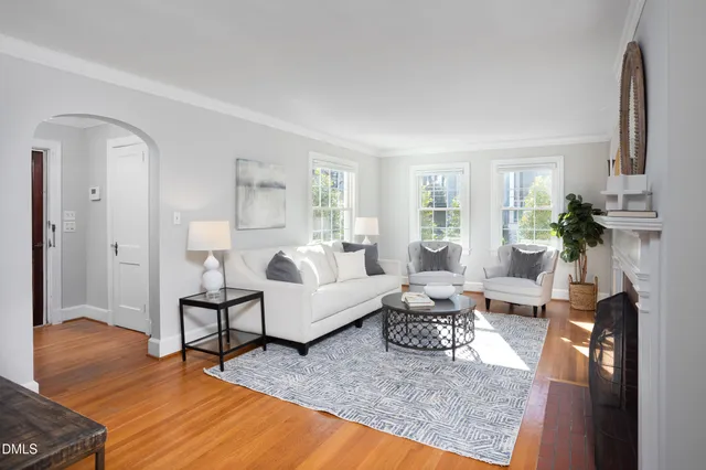 a living room with furniture a window and a fireplace