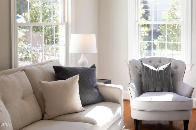 a living room with furniture a fireplace and window