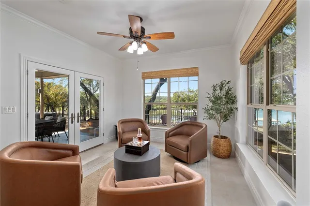 a living room with furniture and a floor to ceiling window