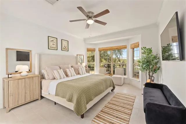 a bedroom with a large bed and a large window