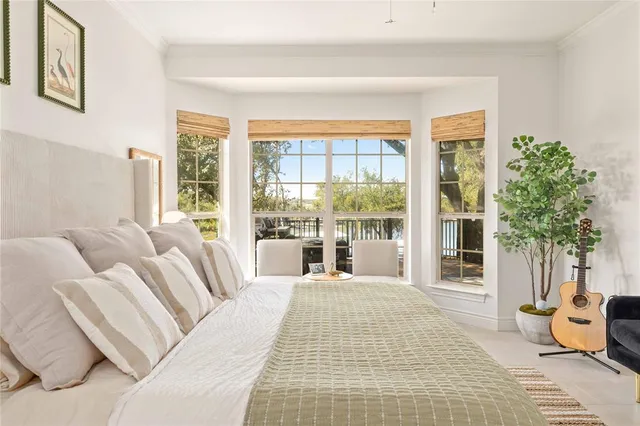 a spacious bedroom with a large bed and a large window with outer view